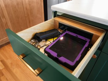 Modern luxury kitchen remodel in Corvallis, Oregon featuring electronics drawer in kitchen island