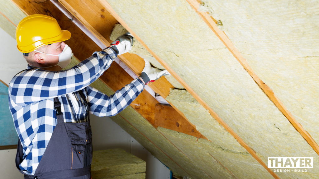 Contractor installing insulation in Corvallis home to make it more energy-efficient.