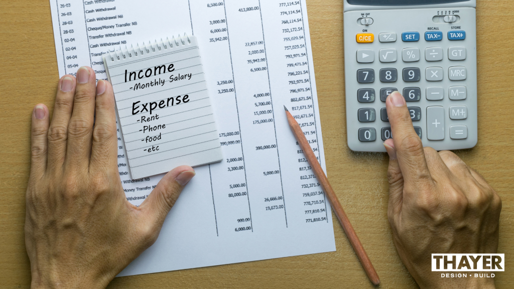 Corvallis man calculating monthly budget and savings from his energy-efficient home