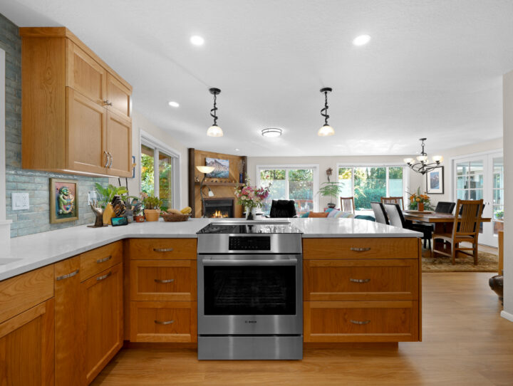 View of kitchen peninsula and living room in Corvallis whole home remodel