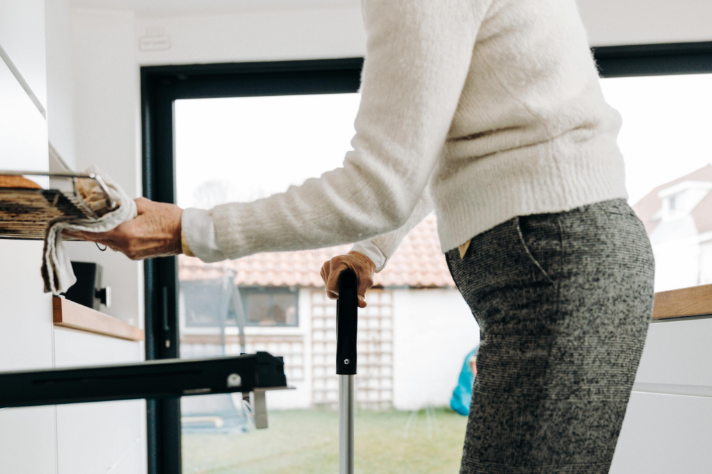 older woman cooking dinner in a kitchen designed for aging-in-place